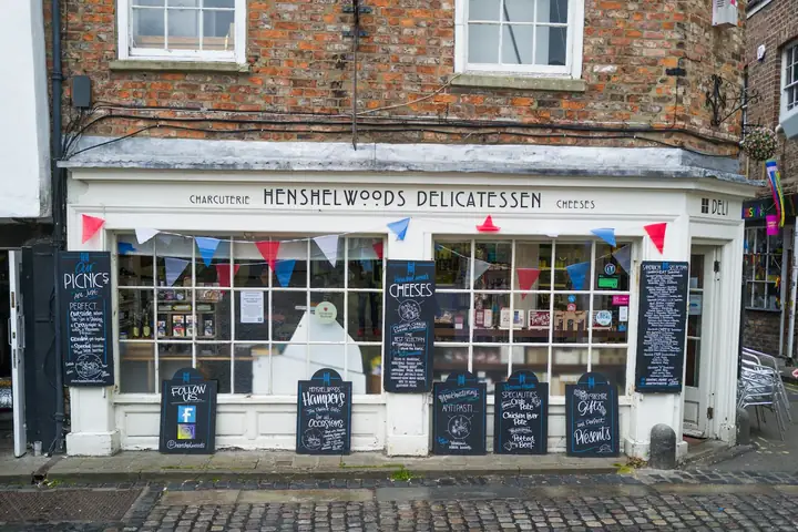 Shopfront of a delicatessen on a brick high street